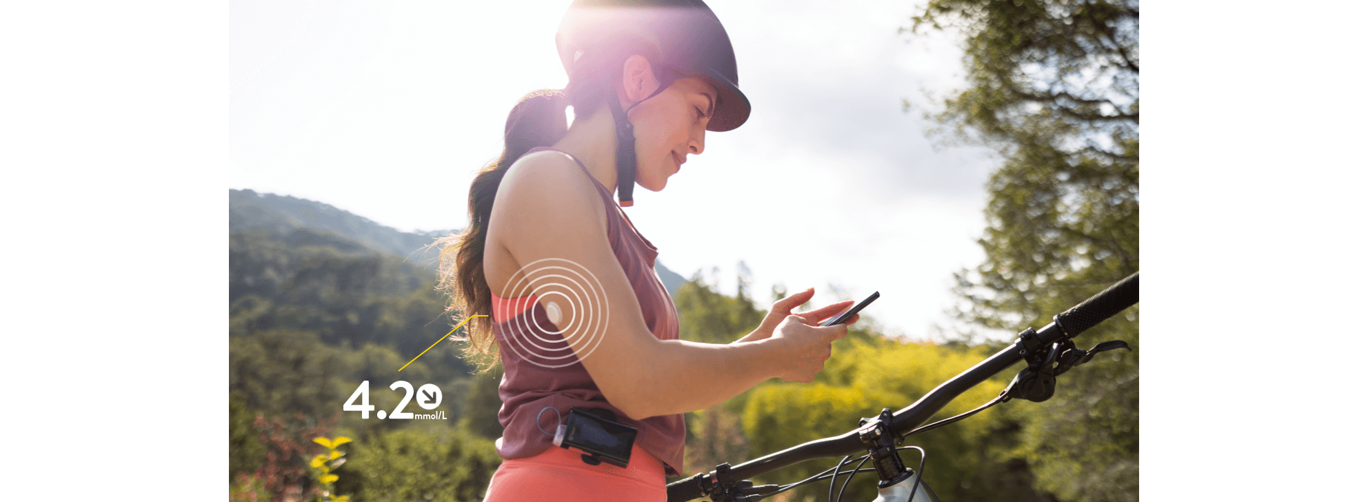 Biker with sensor looking at her phone