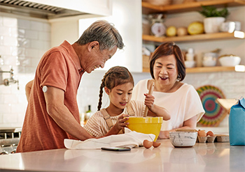 Grandparents spending quality time with their grandchild in the kitchen